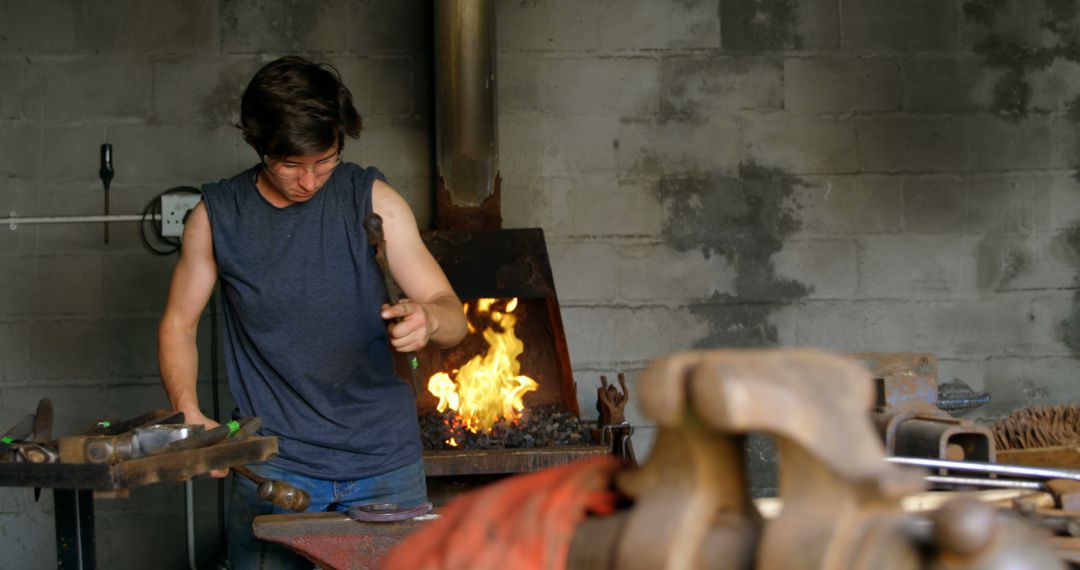 Male Blacksmith Working in Forge - Free Images, Stock Photos and Pictures on Pikwizard.com