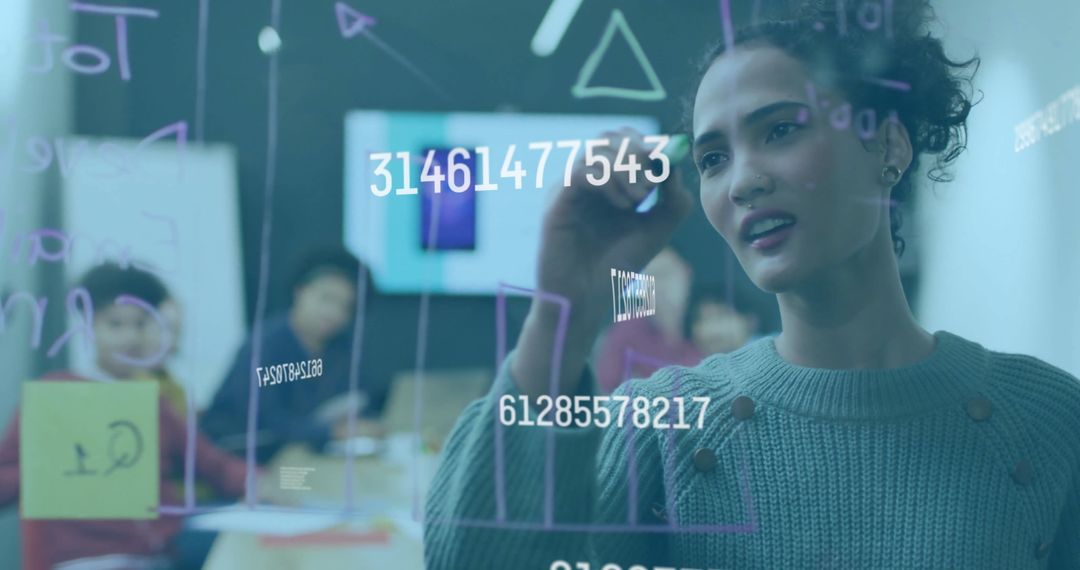 Woman Analyzing Data on Transparent Screen in Classroom