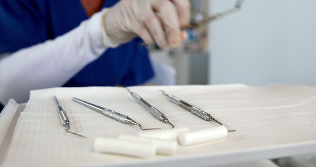A healthcare professional, a dentist, prepares dental instruments for a procedure, with copy space - Free Images, Stock Photos and Pictures on Pikwizard.com
