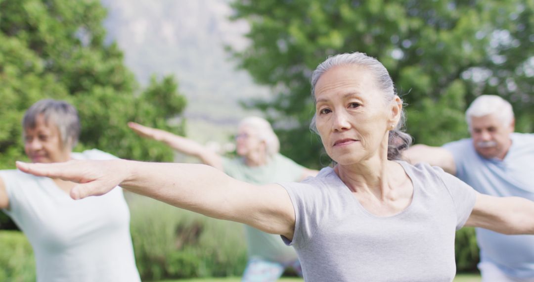 Group of Seniors Practicing Yoga Outdoors in Green Park - Free Images, Stock Photos and Pictures on Pikwizard.com