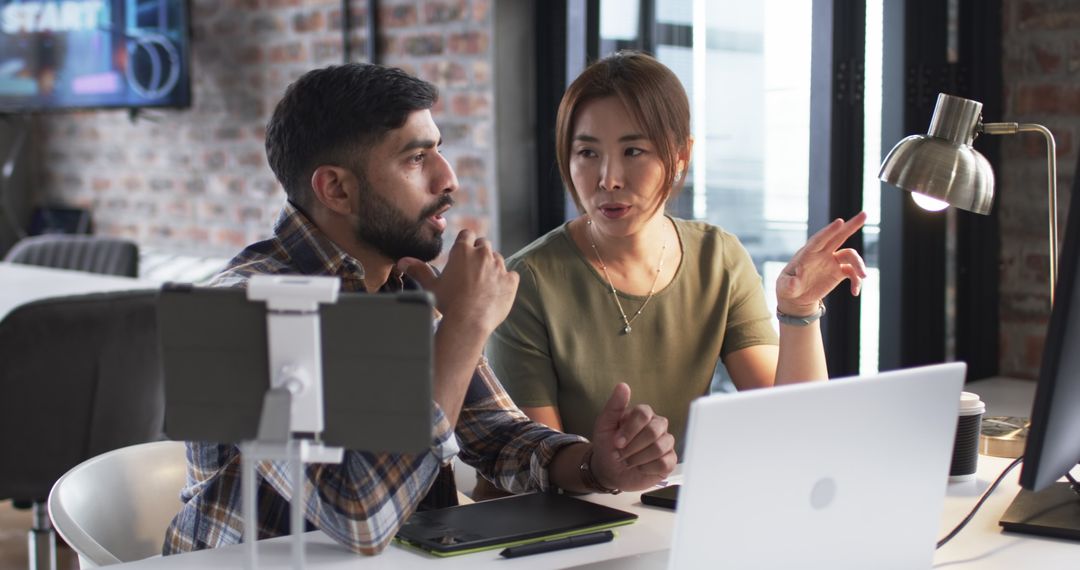 Two Collegues Engaged in Work Discussion in Modern Office
