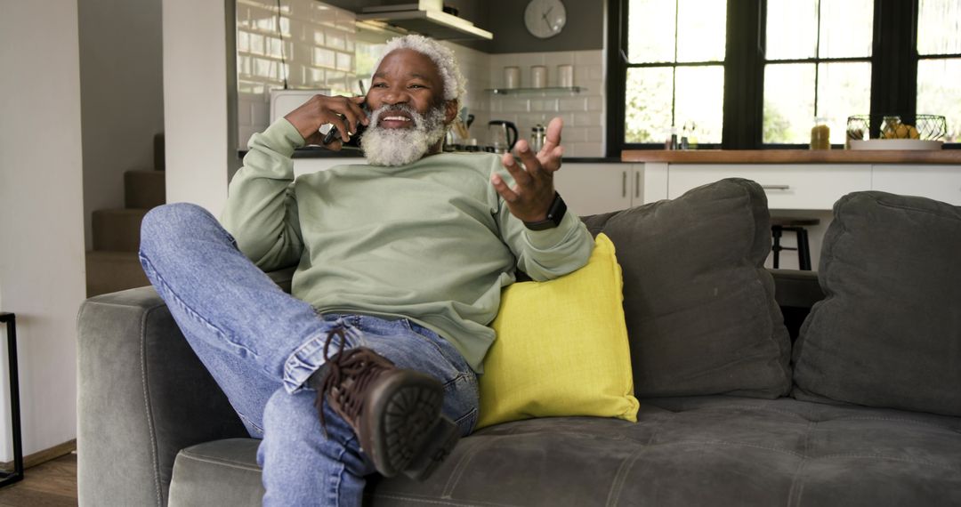 Senior Man Enjoying Conversation on Smartphone at Home