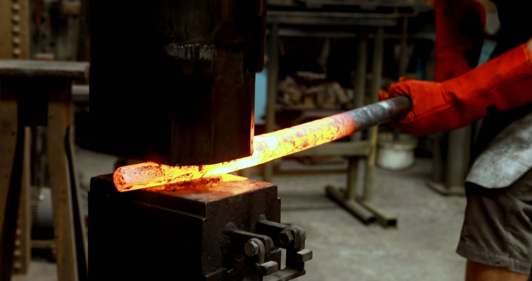 Blacksmith Shaping Glowing Metal Rod with Power Hammer in Workshop - Free Images, Stock Photos and Pictures on Pikwizard.com