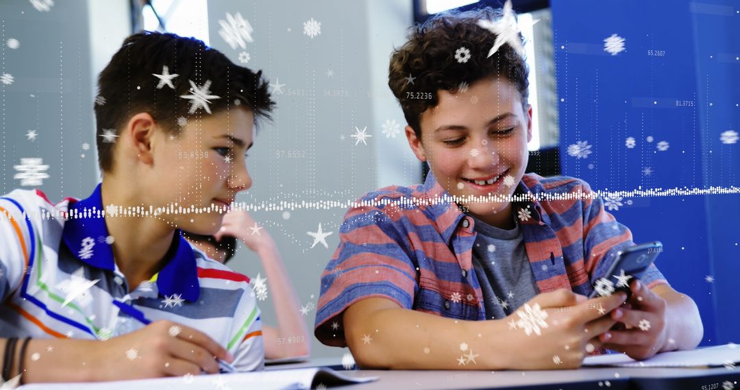 Two Boys Using Smartphone with Digital Snowflake Overlay in Classroom