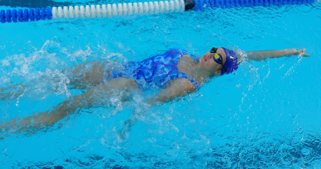 Female Swimmer Performing Backstroke in Pool - Free Images, Stock Photos and Pictures on Pikwizard.com