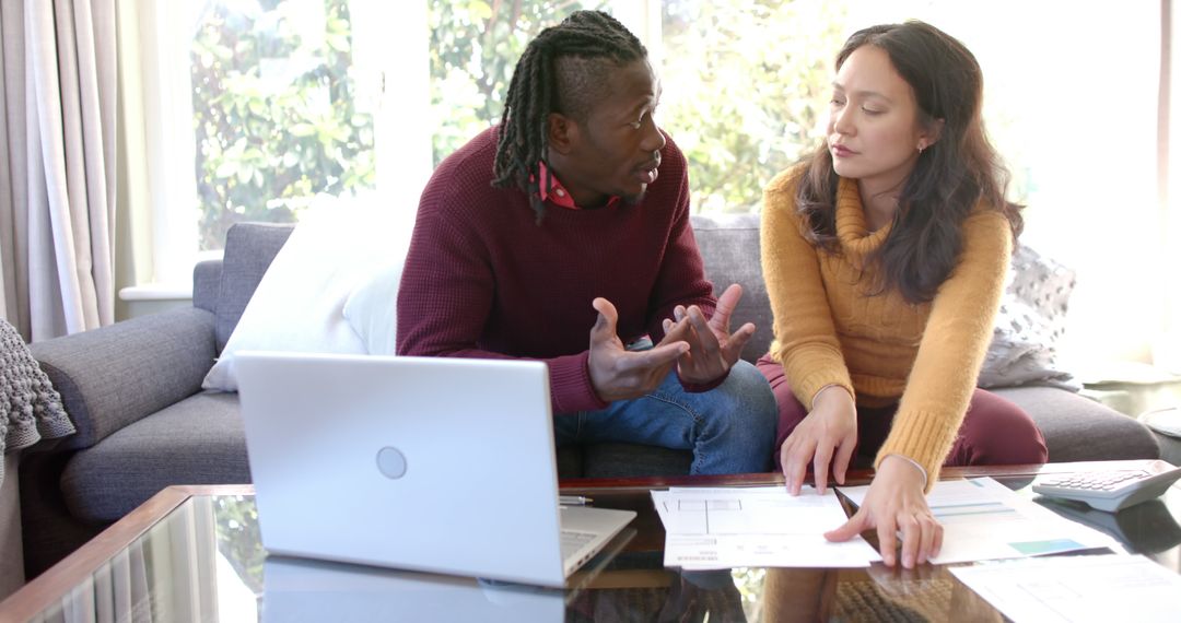 Diverse Couple Discussing Domestic Finances in Living Room