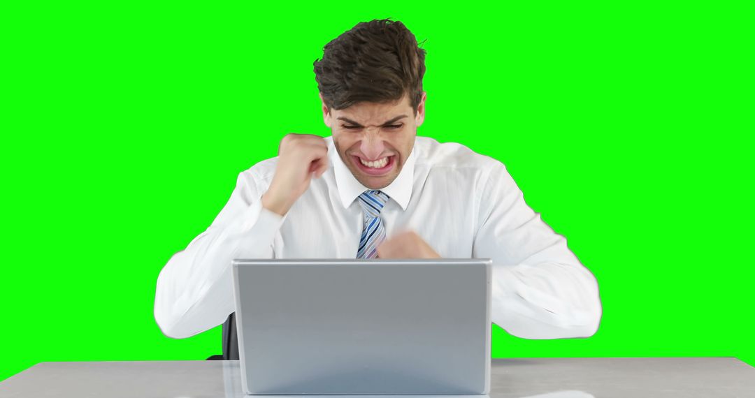 Frustrated businessman working on laptop with green screen background - Free Images, Stock Photos and Pictures on Pikwizard.com