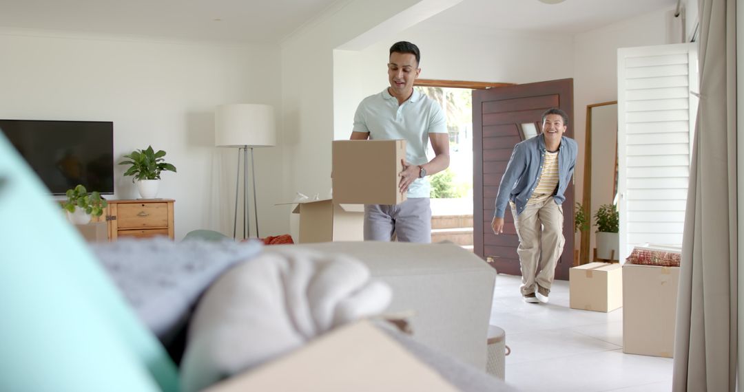 Diverse Couple Moving into New Home with Cardboard Boxes