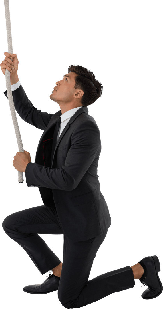 Businessman in Suit Kneeling While Pulling Transparent Rope