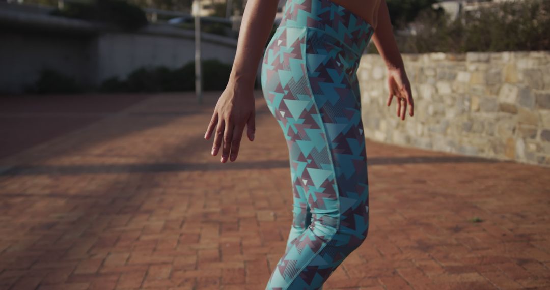 Woman Exercising Outdoors in Stylish Geometric Print Leggings - Free Images, Stock Photos and Pictures on Pikwizard.com