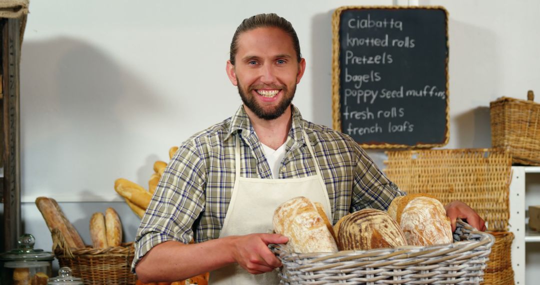 Smiling Baker Holding Freshly Baked Artisanal Bread in Bakery - Free Images, Stock Photos and Pictures on Pikwizard.com