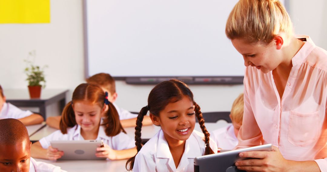 Teacher Engaging with Elementary School Students Using Tablets - Free Images, Stock Photos and Pictures on Pikwizard.com