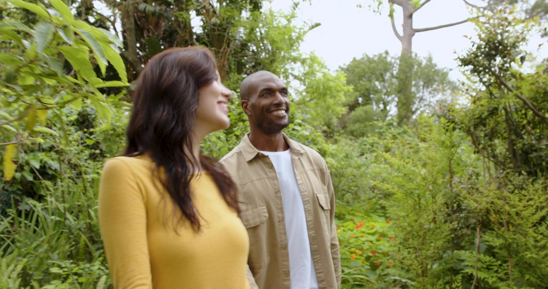 Diverse Couple Enjoying Leisurely Walk in Lush Botanical Garden