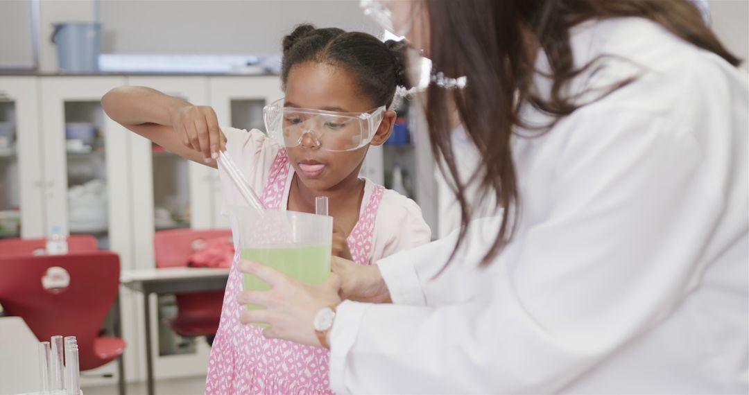 Young Girl Conducting Science Experiment with Teacher's Assistance in Laboratory - Free Images, Stock Photos and Pictures on Pikwizard.com