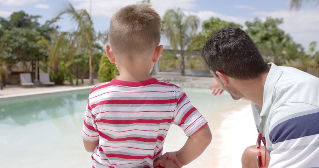 Father and Son Enjoying Time Poolside on Sunny Day - Free Images, Stock Photos and Pictures on Pikwizard.com