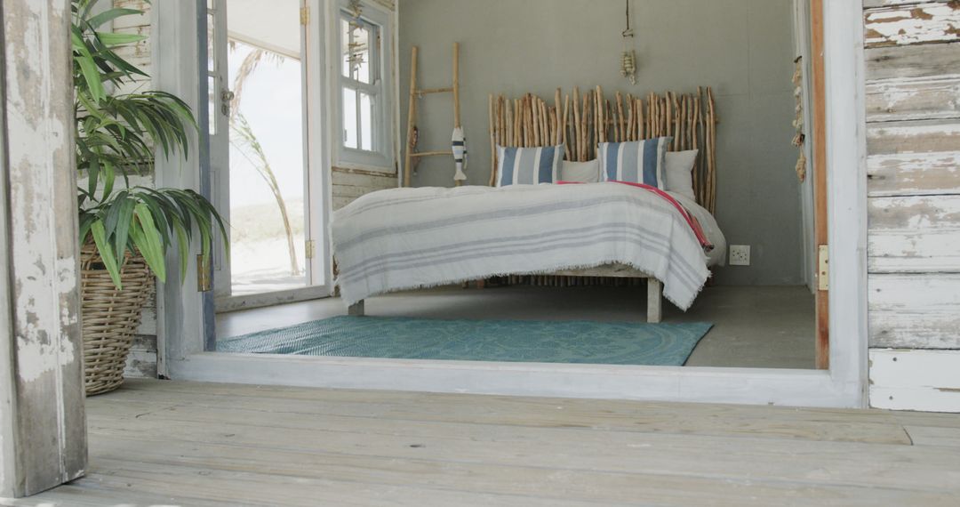 Empty room of beach house with wooden decorations and big bed - Free Images, Stock Photos and Pictures on Pikwizard.com
