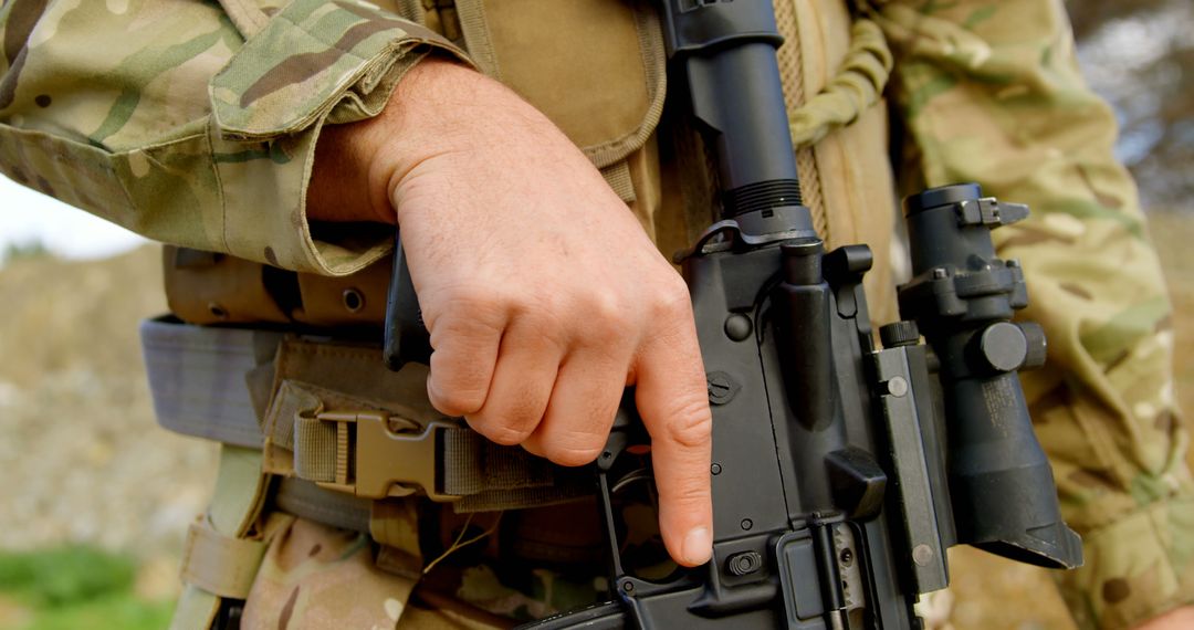 Close-up of Soldier Pointing at Rifle Trigger Guard - Free Images, Stock Photos and Pictures on Pikwizard.com
