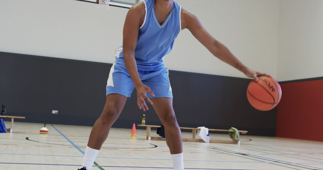 Focused Basketball Player Practicing Dribbling on Indoor Court - Free Images, Stock Photos and Pictures on Pikwizard.com