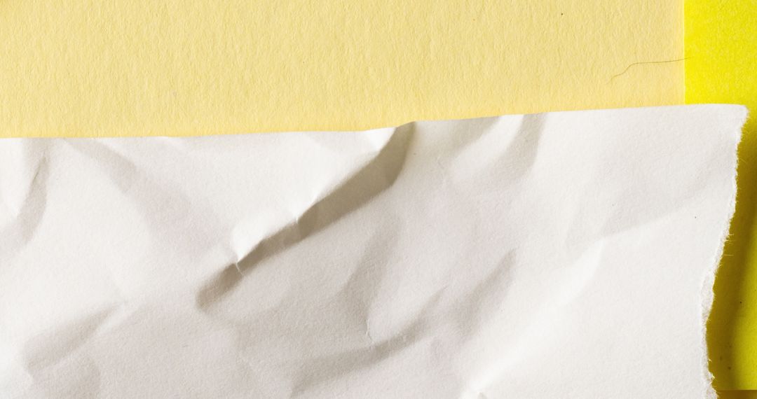 Crumpled White Paper on Bold Yellow Background