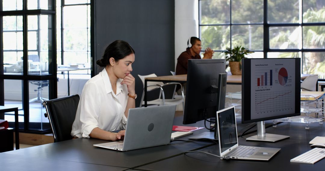 Focused Professionals Analyzing Data in Modern Office Space