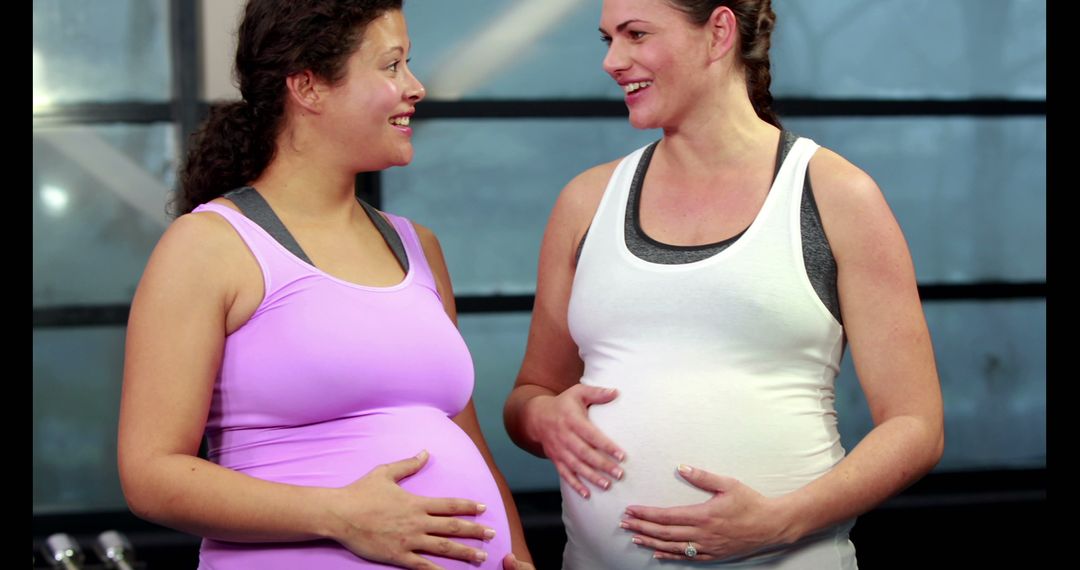 Two Pregnant Women Smiling and Chatting at Gym - Free Images, Stock Photos and Pictures on Pikwizard.com