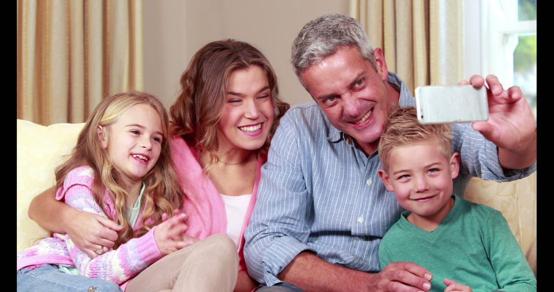 Happy Family Taking Selfie Together on Living Room Sofa - Free Images, Stock Photos and Pictures on Pikwizard.com