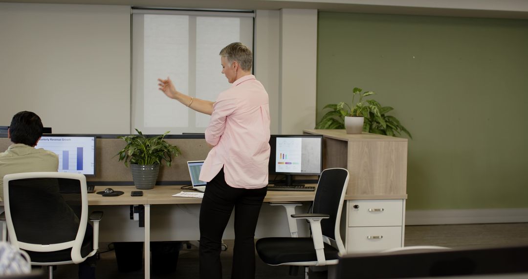 Office Team Engaged in Data Presentation and Discussion