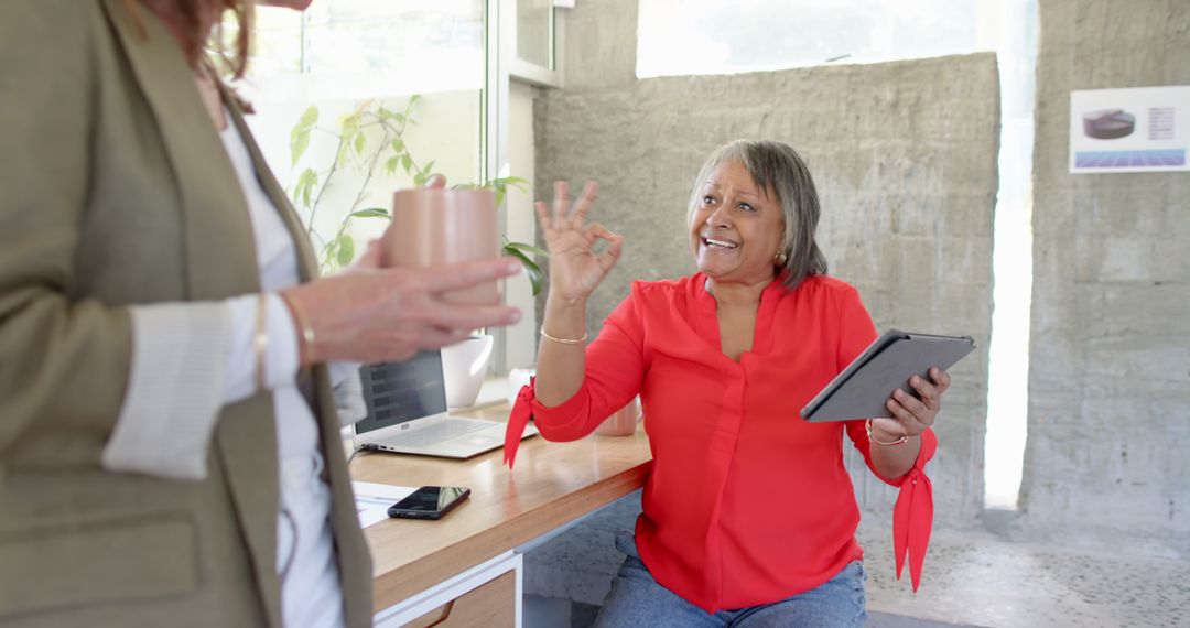 Senior Executive Engaged in Productive Office Discussion with Team