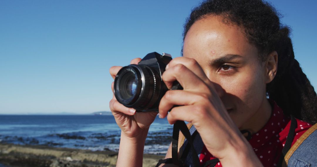 Female Photographer Capturing Ocean Scenery on a Clear Day - Free Images, Stock Photos and Pictures on Pikwizard.com