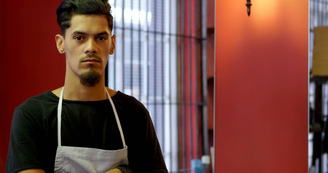 Young male barber standing proudly in hair salon - Free Images, Stock Photos and Pictures on Pikwizard.com