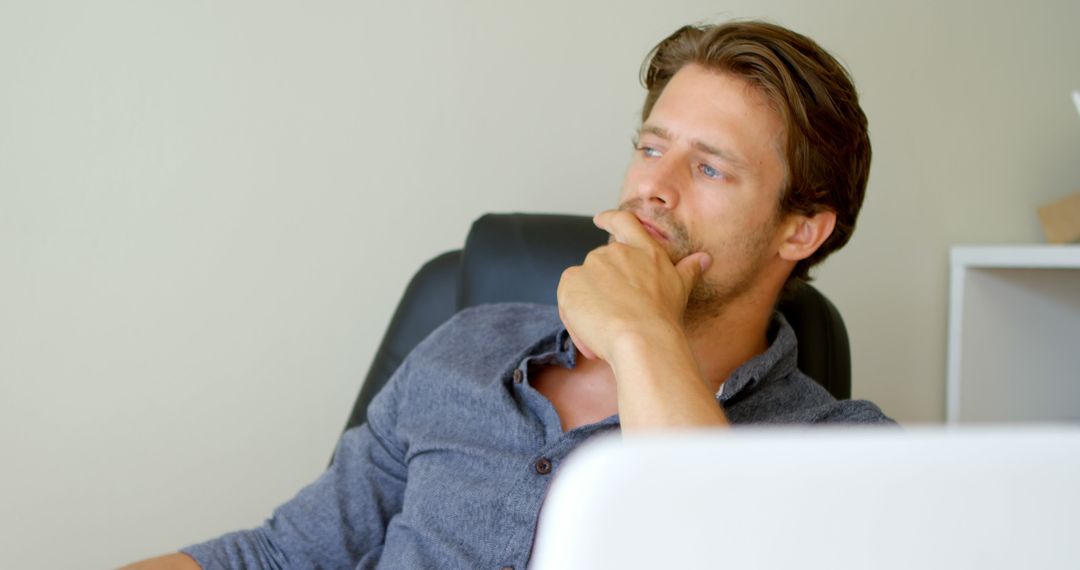 Pensive Professional Contemplating Work Strategy at Desk