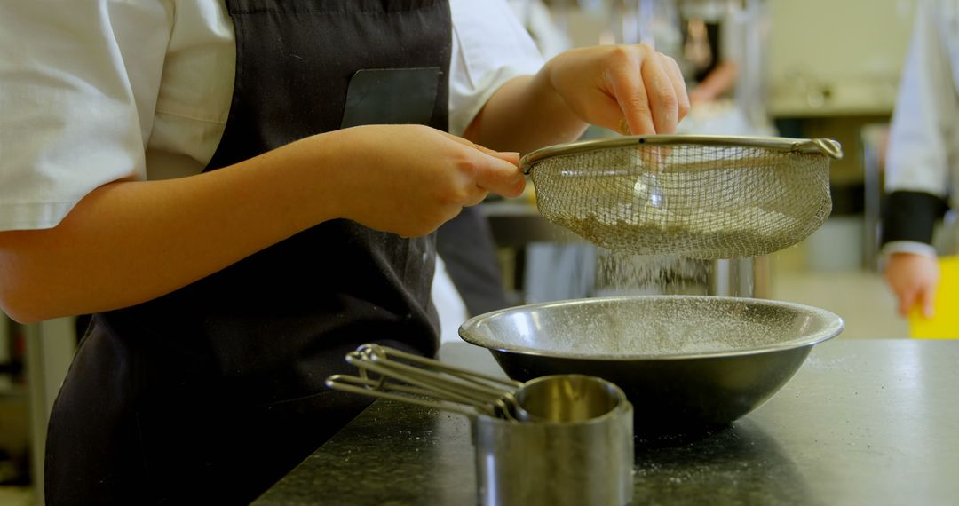 Professional Chef Sifting Flour in Kitchen - Free Images, Stock Photos and Pictures on Pikwizard.com