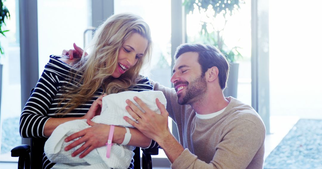 Joyful Parents Holding Newborn Baby in Hospital Room - Free Images, Stock Photos and Pictures on Pikwizard.com