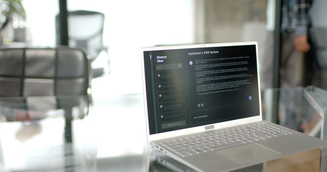 Laptop Displaying AI Chatbot Interface on Glass Desk in Modern Home Office