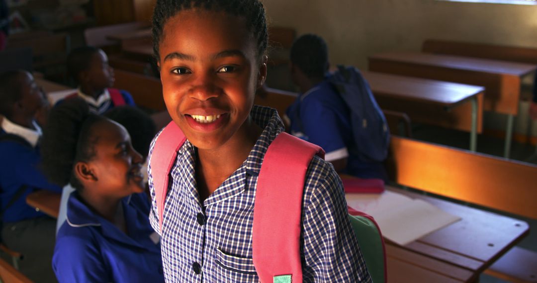 Smiling Schoolchild Wearing Backpack Inside Classroom