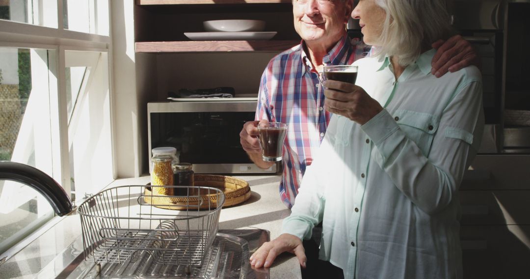 Senior Couple Enjoying Morning Coffee in Sunlit Kitchen - Free Images, Stock Photos and Pictures on Pikwizard.com