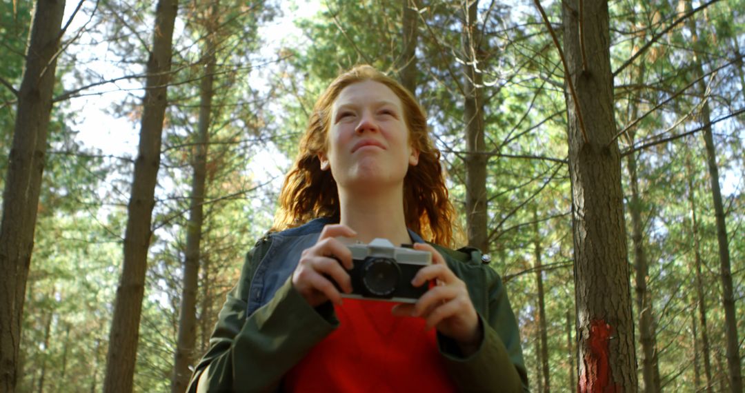 Woman Holding Camera in Forest, Enjoying Nature and Photography - Free Images, Stock Photos and Pictures on Pikwizard.com