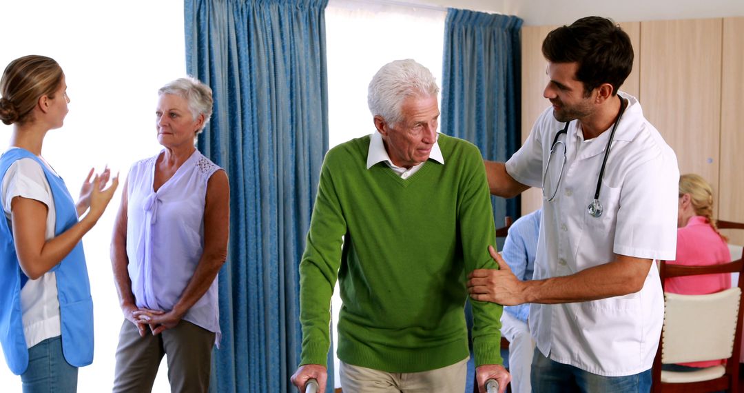 Team of caregivers assisting elderly man with walker in care home - Free Images, Stock Photos and Pictures on Pikwizard.com