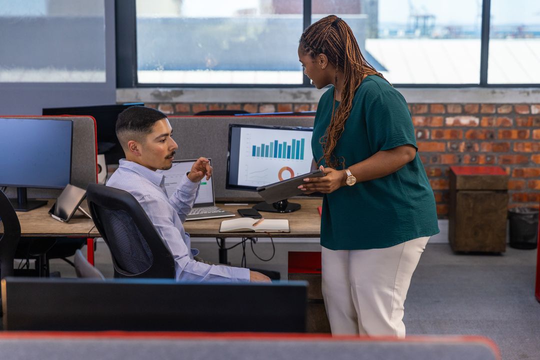 Colleagues Collaborating in Modern Open-Plan Office Environment