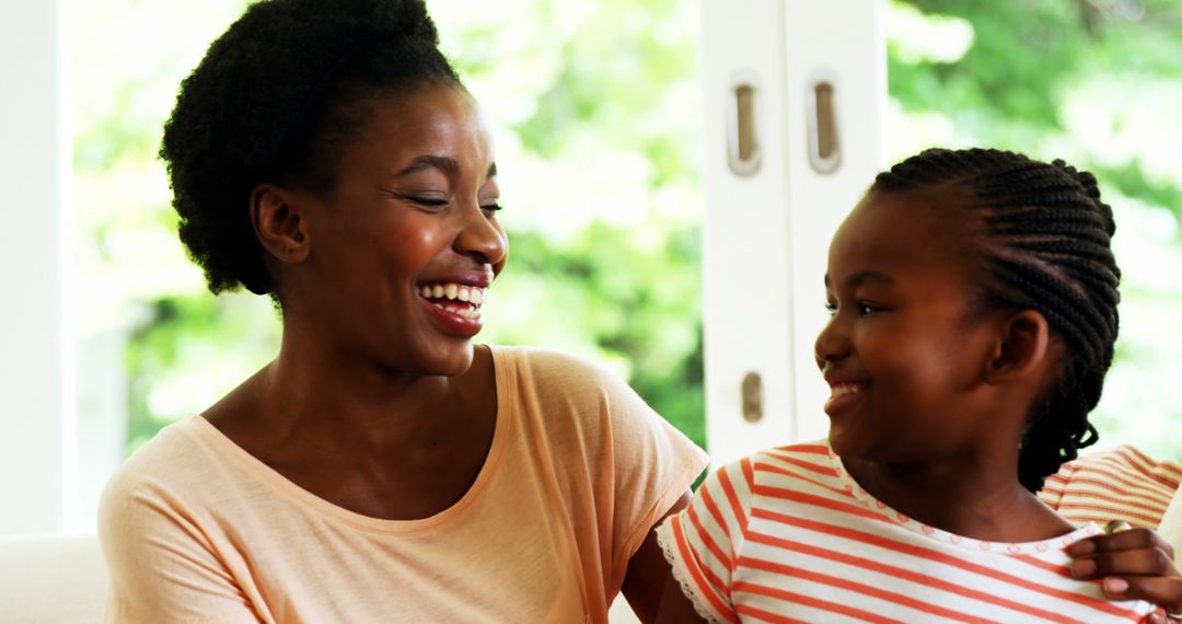 African American Mother and Daughter Sharing Joyful Moment Together - Free Images, Stock Photos and Pictures on Pikwizard.com