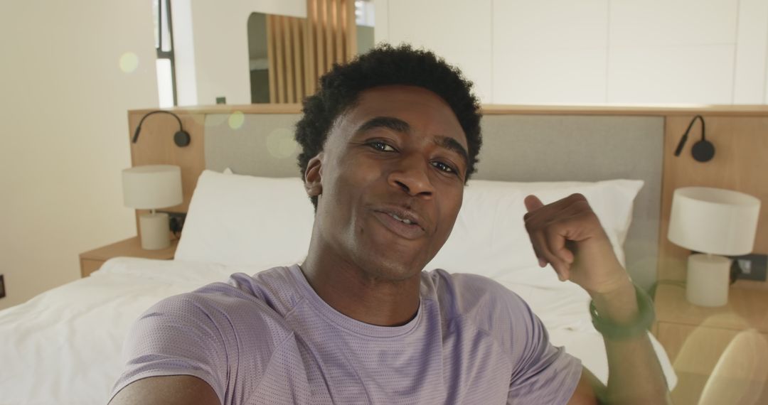 Smiling Man Relaxing in Modern Bedroom Interaction