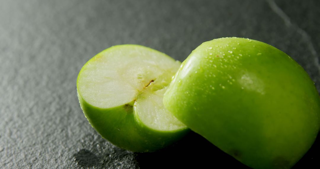 Freshly Sliced Green Apple on Slate Background
