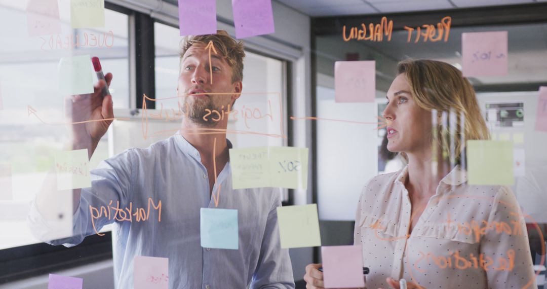 Business Team Brainstorming with Glass Board and Sticky Notes
