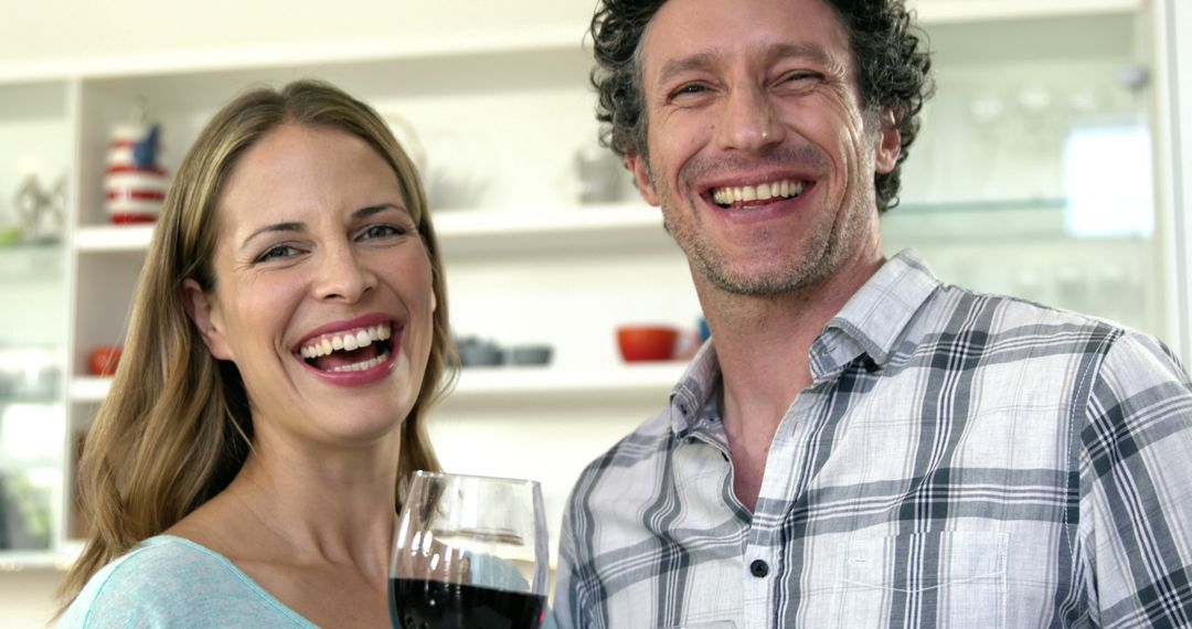 Couple drinking red wine in the kitchen - Free Images, Stock Photos and Pictures on Pikwizard.com