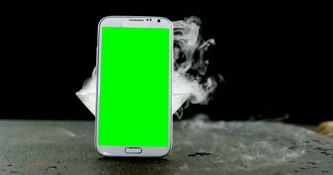 Smartphone with Green Screen Background in Dramatic Smoke - Free Images, Stock Photos and Pictures on Pikwizard.com