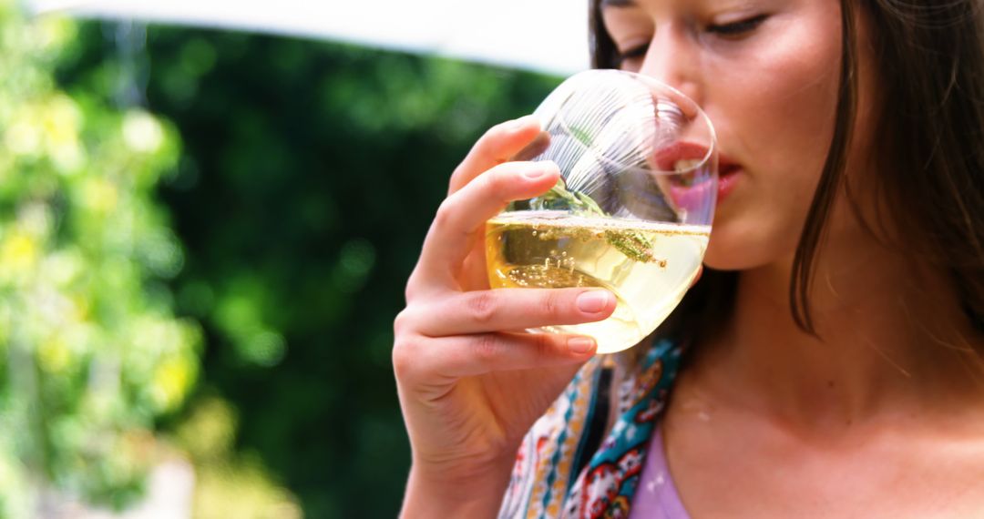 Woman Enjoying Glass of White Wine Outdoors - Free Images, Stock Photos and Pictures on Pikwizard.com