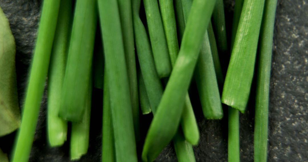 Close-Up of Fresh Green Chives on Dark Slate Surface - Free Images, Stock Photos and Pictures on Pikwizard.com