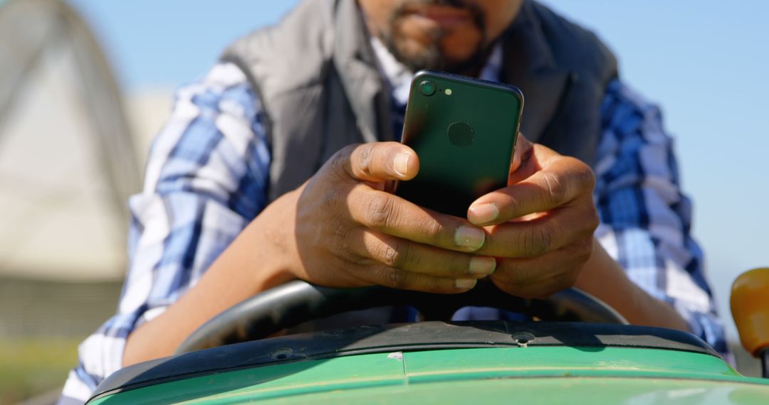 Farmer Using Smartphone while Driving Tractor - Free Images, Stock Photos and Pictures on Pikwizard.com