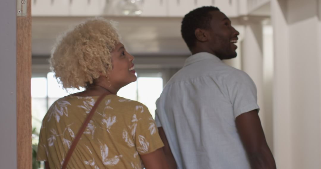 Couple Returning Home with Luggage Sharing Joyful Emotion