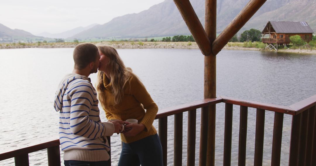 Romantic Couple Kissing on Lakefront Balcony in Nature - Free Images, Stock Photos and Pictures on Pikwizard.com